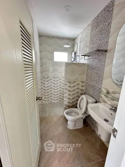 Modern bathroom with stylish tile design and compact layout