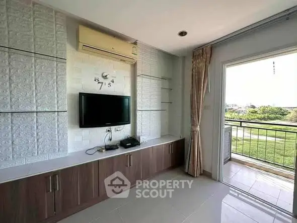 Modern living room with built-in TV unit and balcony view