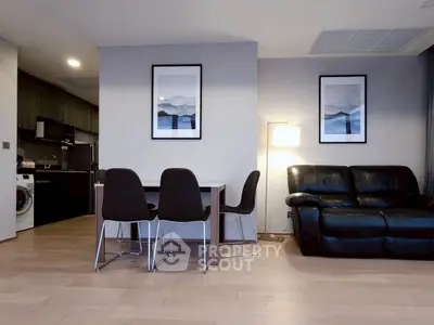 Modern living room with sleek furniture and open kitchen layout
