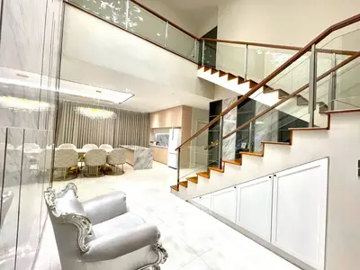 Luxurious modern interior with elegant staircase and dining area