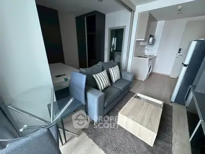 Modern studio apartment with open layout, featuring cozy living area and compact kitchen.