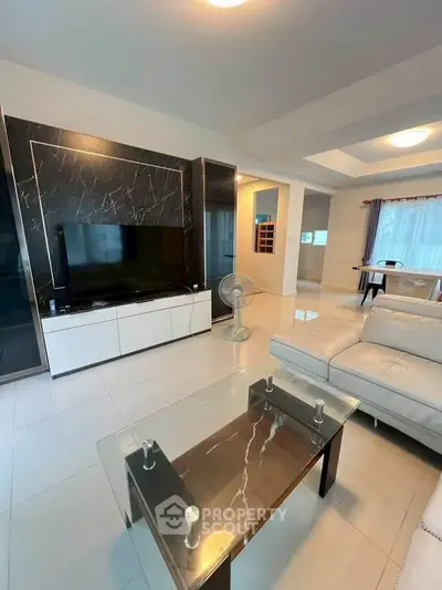 Spacious modern living room with elegant marble accents and sleek furniture