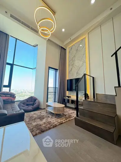 Luxurious living room with high ceilings and stunning city view, featuring modern decor and elegant lighting.