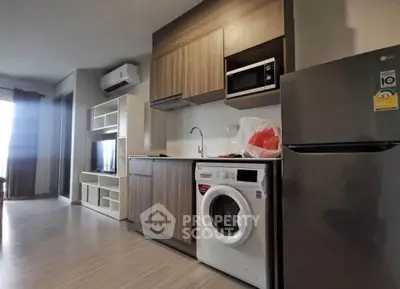 Modern kitchen with integrated appliances and sleek cabinetry in a stylish apartment.