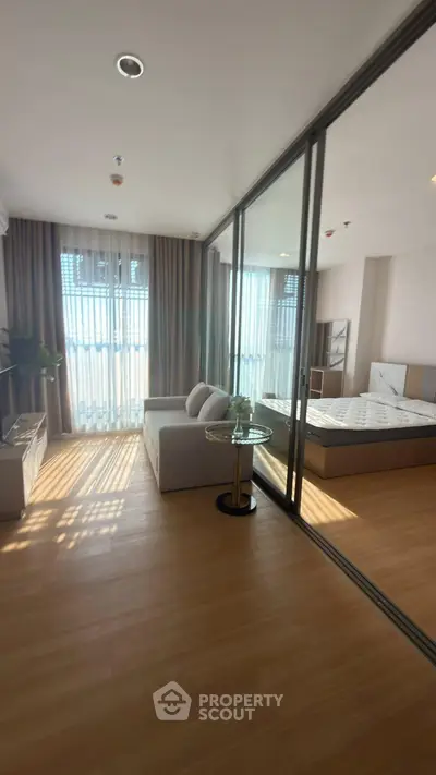 Modern studio apartment with glass partition and natural light