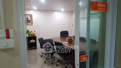 Modern office meeting room with sleek chairs and round table, ideal for productive discussions.