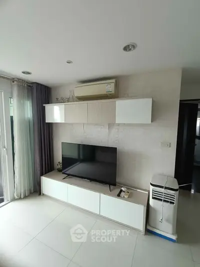 Modern living room with sleek TV unit and air conditioning