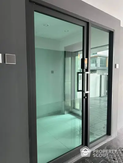 Modern glass entrance with sleek design and contemporary architecture