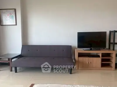 Modern living room with sleek sofa and entertainment unit, perfect for relaxation and entertainment.