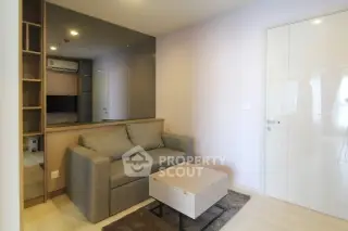 Modern living room with sleek sofa and stylish decor in a contemporary apartment.