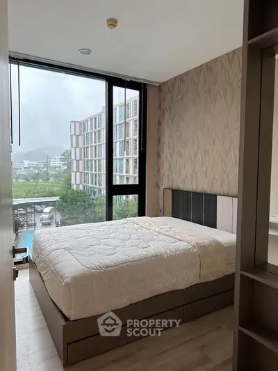 Modern bedroom with large window and scenic view in stylish apartment