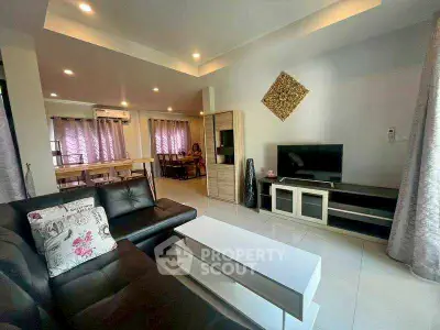 Spacious modern living room with stylish decor and ample natural light.
