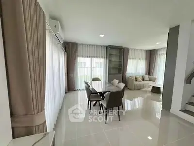 Spacious modern living room with elegant dining area and large windows