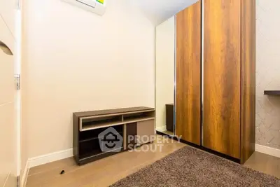 Modern bedroom with wooden wardrobe and air conditioning