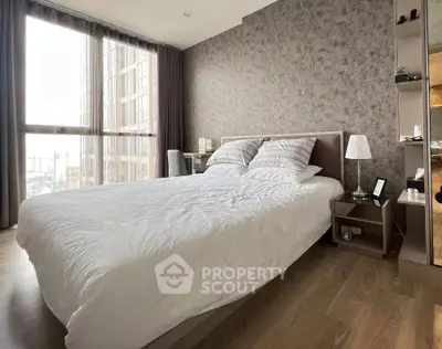 Modern bedroom with large windows and stylish decor in a high-rise apartment.