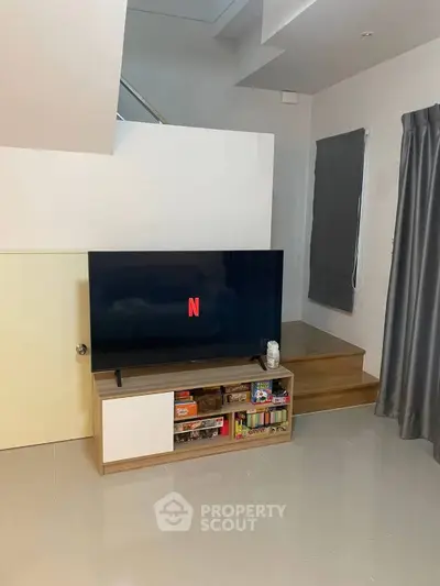 Modern living room with sleek TV setup and stylish decor, perfect for entertainment and relaxation.