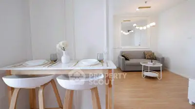 Modern open-plan living room with stylish dining area and cozy seating.