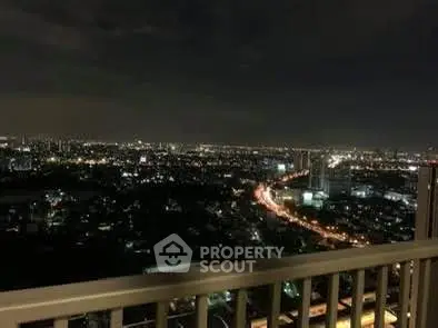 Stunning nighttime cityscape view from a high-rise balcony, perfect for urban living enthusiasts.