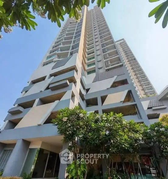 Stunning high-rise building with modern architecture and lush greenery