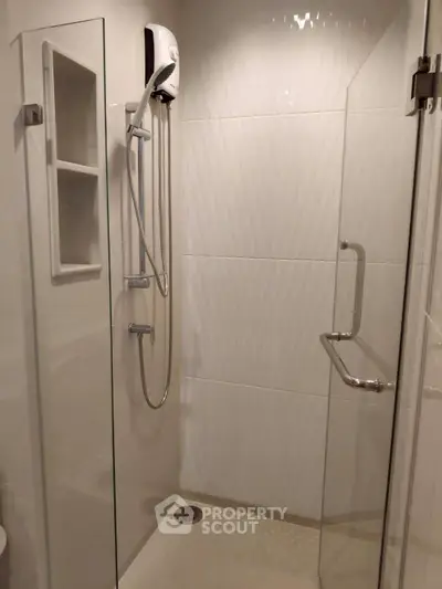 Modern bathroom with sleek shower enclosure and built-in shelves