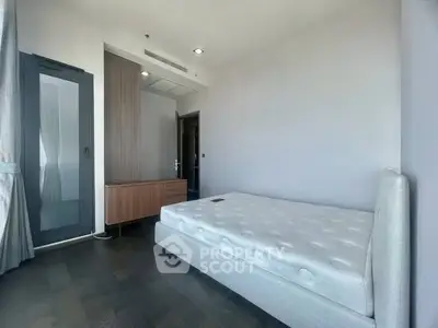 Spacious bedroom with modern design and ample natural light