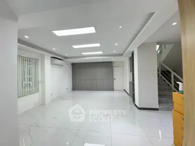 Spacious modern interior with sleek design and ample natural light, perfect for versatile living spaces.