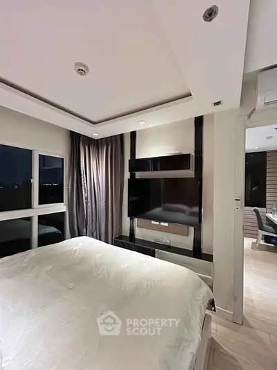 Luxurious bedroom with modern decor and large window view
