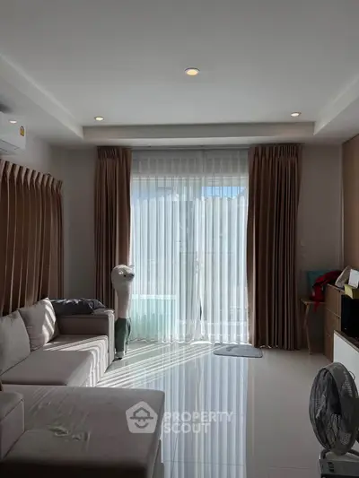 Bright living room with large window and modern decor