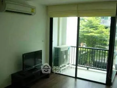Modern living room with balcony view and air conditioning in urban apartment.