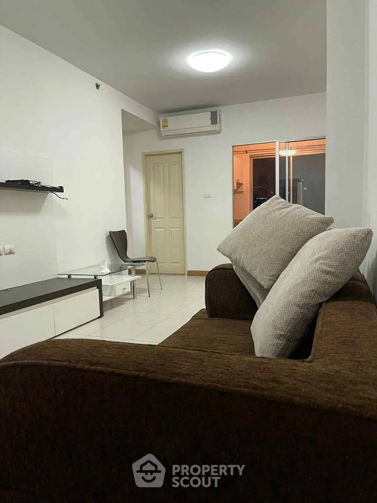 Cozy living room with modern sofa and sleek decor in a stylish apartment.