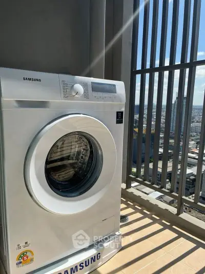 Modern washing machine on a sunny balcony with city view, perfect for urban living convenience.