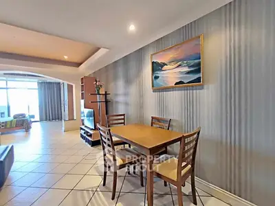 Spacious living room with dining area and modern decor in a bright apartment.