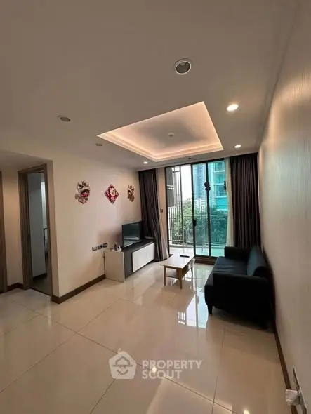 Spacious modern living room with large windows and sleek furnishings