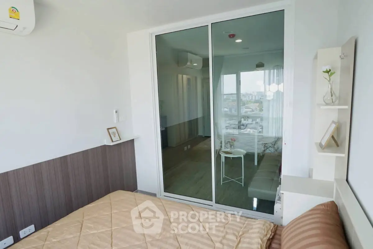 Modern bedroom with glass partition and cozy decor in urban apartment