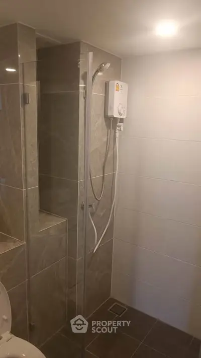 Modern bathroom with sleek shower and neutral tiles
