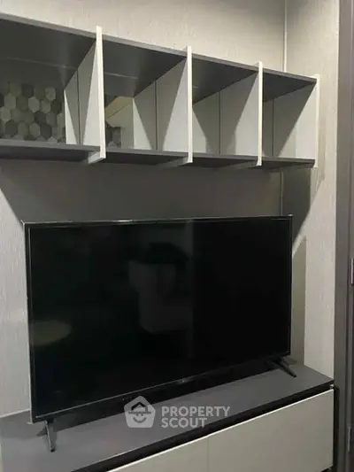 Modern living room with sleek TV and stylish shelving unit