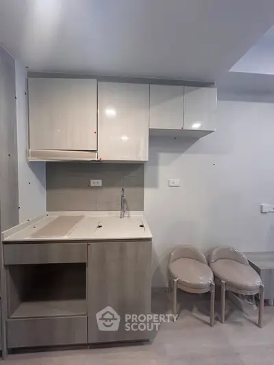 Modern compact kitchen with sleek cabinetry and minimalist design