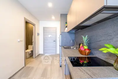 Modern kitchen with sleek design and induction cooktop in a stylish apartment.