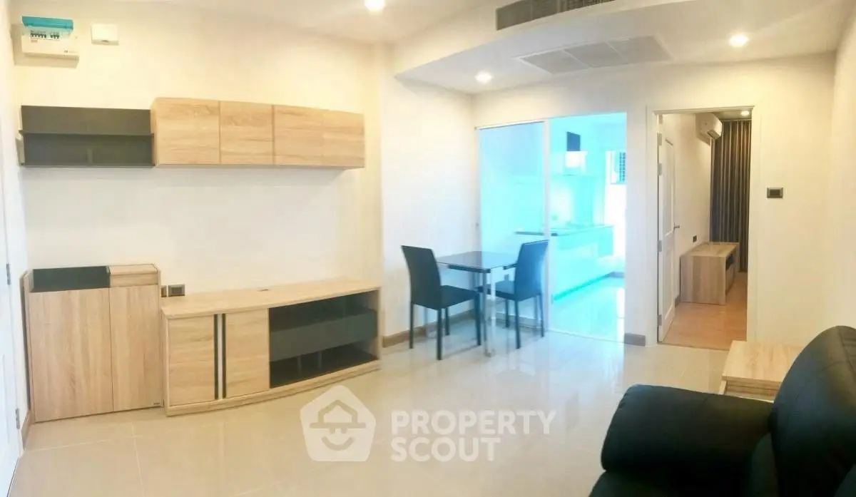 Modern living room with sleek furniture and open kitchen layout