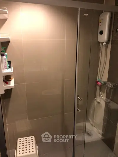 Modern bathroom with glass shower enclosure and wall-mounted water heater