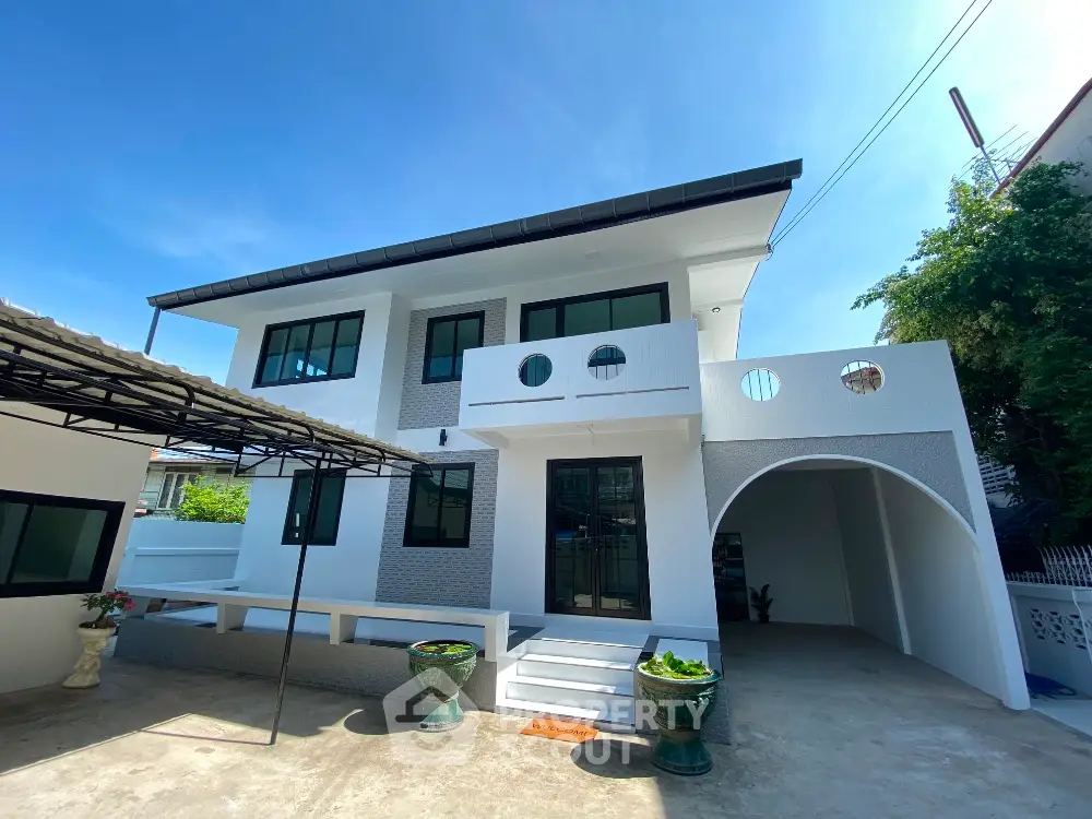 Modern two-story house with unique architectural design and spacious outdoor area