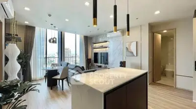Luxurious open-plan living room with modern kitchen and stunning city view.