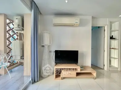 Modern living room with sleek TV stand and air conditioning, featuring a stylish floor lamp and balcony view.