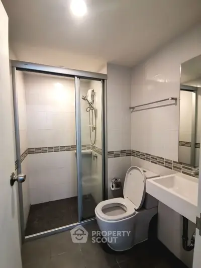 Modern bathroom with glass shower enclosure and sleek fixtures