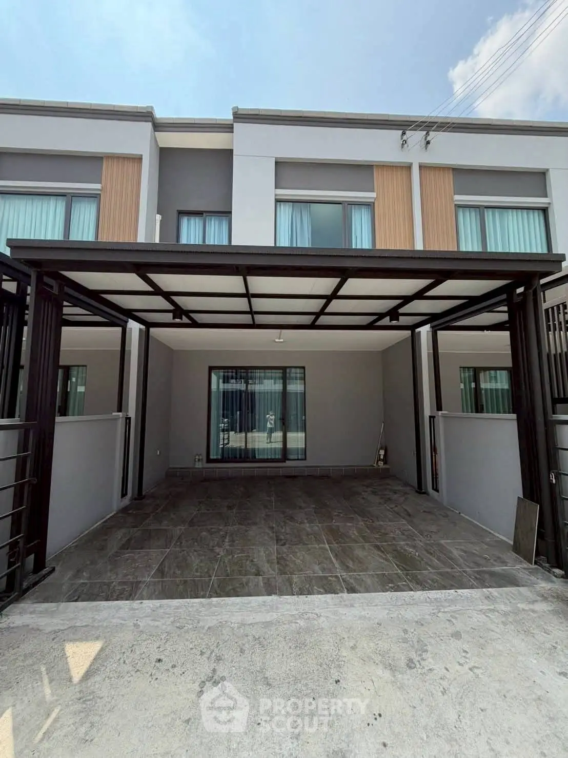 Modern townhouse exterior with spacious driveway and sleek design