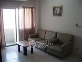 Cozy living room with natural light and balcony access