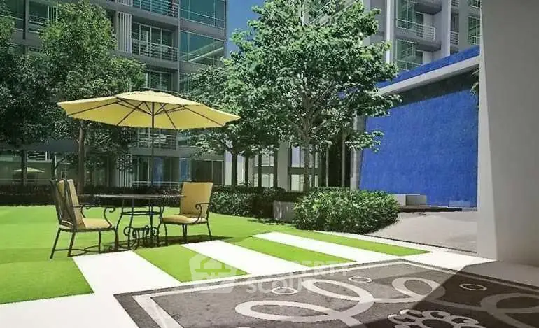 Luxurious outdoor garden area with stylish seating and vibrant greenery in modern apartment complex.