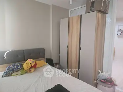 Cozy bedroom with modern wardrobe and plush bedding, perfect for relaxation.