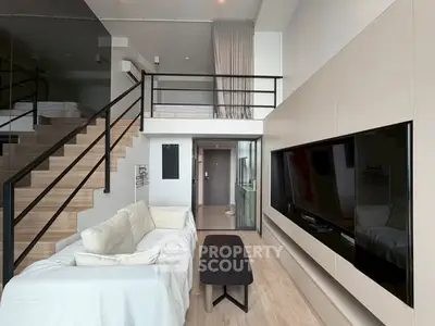 Modern loft apartment with sleek design, featuring a spacious living area and mezzanine bedroom.
