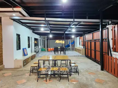 Spacious outdoor patio with modern furniture and stylish lighting, perfect for entertaining guests.